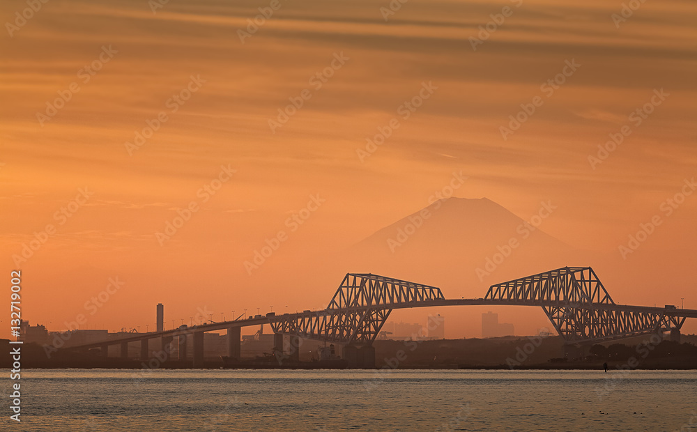 Tokyo bay at sunset with Tokyo gate bridge and Mountain Fuji .