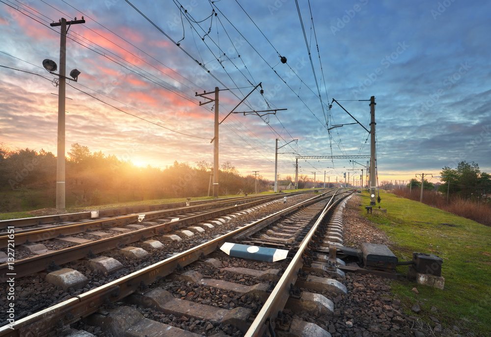 Railroad against beautiful sunny sky. Industrial landscape with railway station, blue sky and colorf