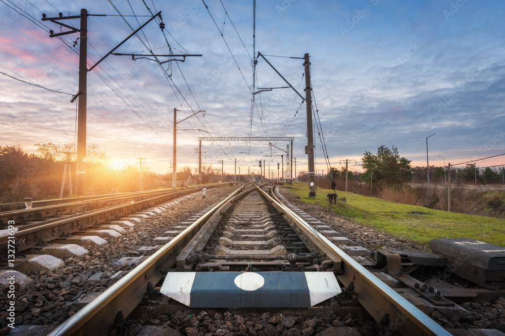 Railway station against beautiful sunny sky. Industrial landscape with railroad, blue sky and colorf