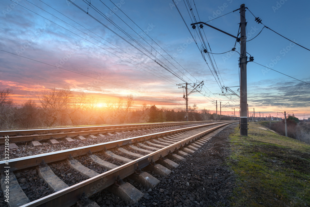 Railway station against beautiful sunny sky. Industrial landscape with railroad, blue sky and colorf