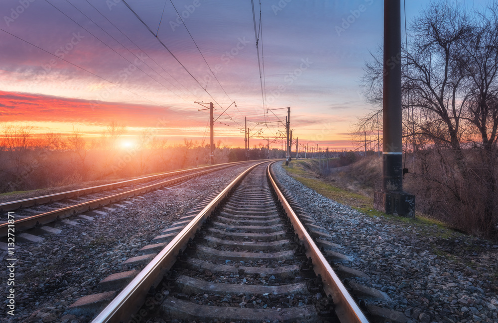 Railroad against beautiful sunny sky. Industrial landscape with railway station, blue sky and colorf