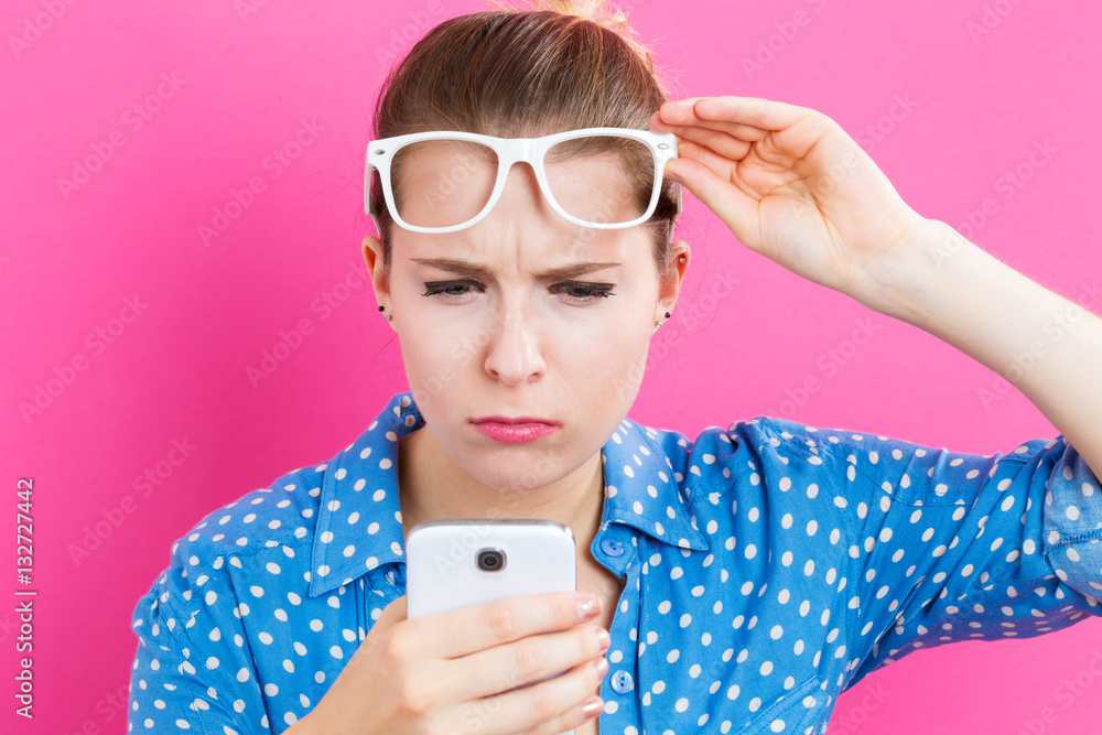 Young woman staring at her cellphone