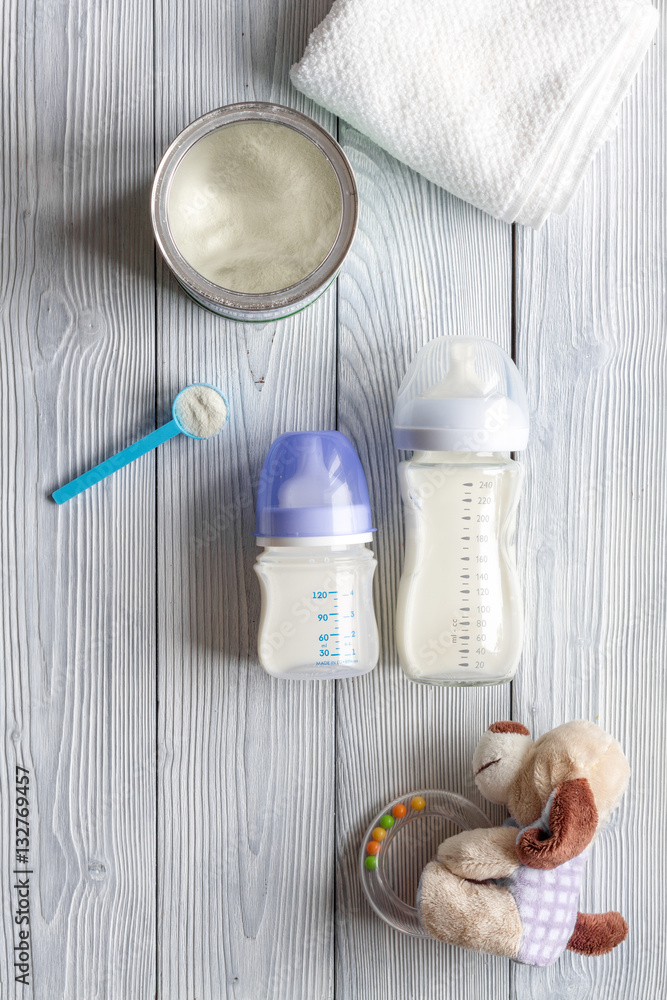 preparation of mixture baby feeding on wooden background top view