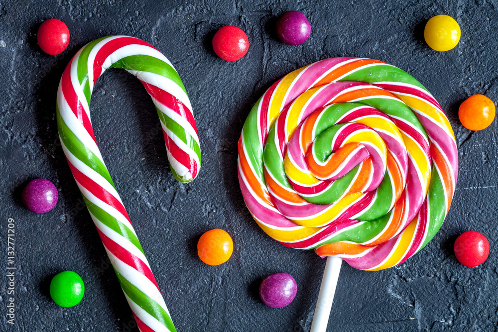 sweets and sugar candies on dark background top view