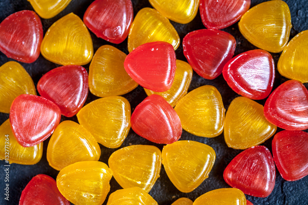 sweets and sugar candies on dark background top view