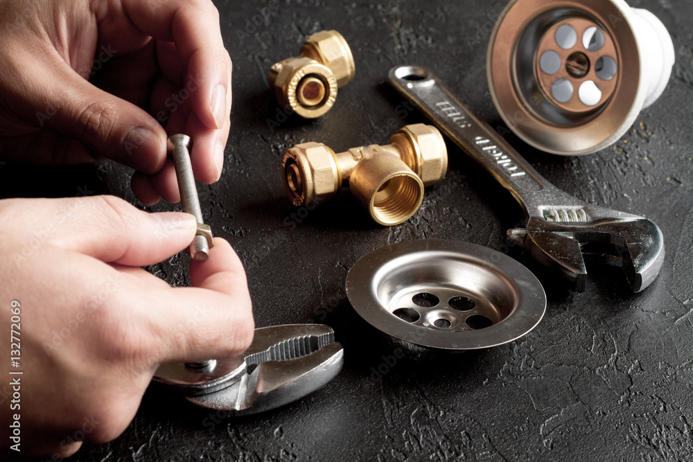 concept plumbing tools on dark background