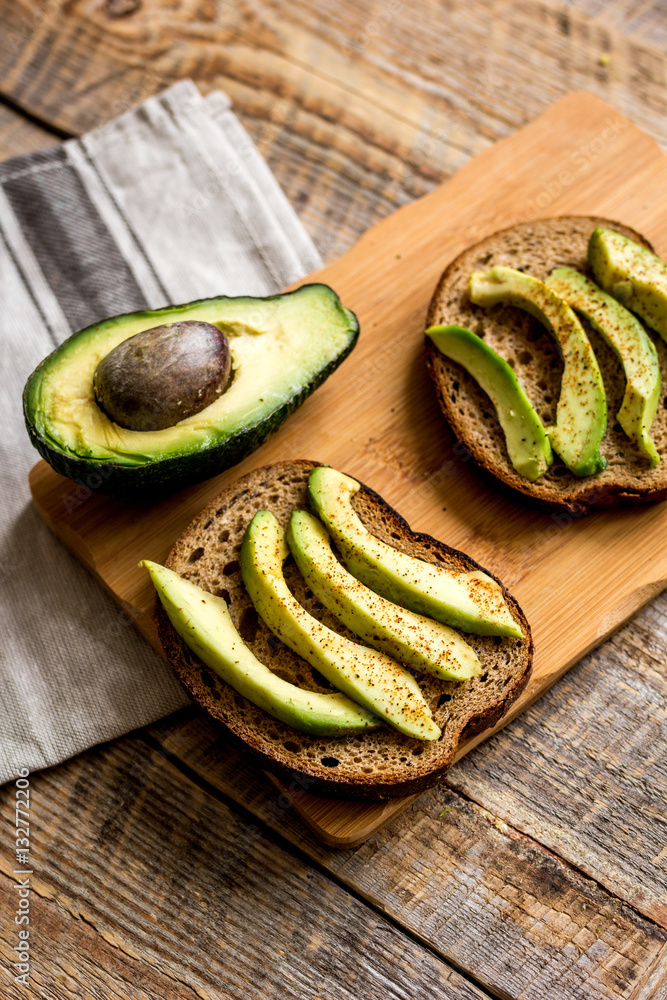 making sandwiches with avocado healthy organic food top view