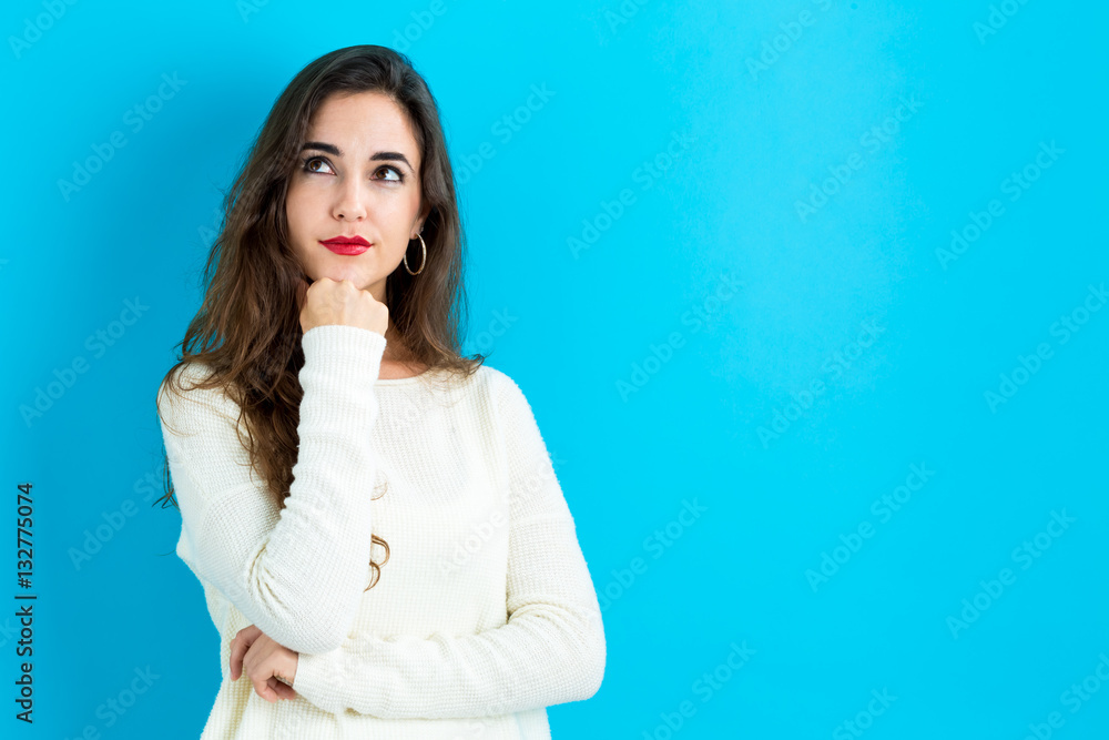 Young woman in a thoughtful pose