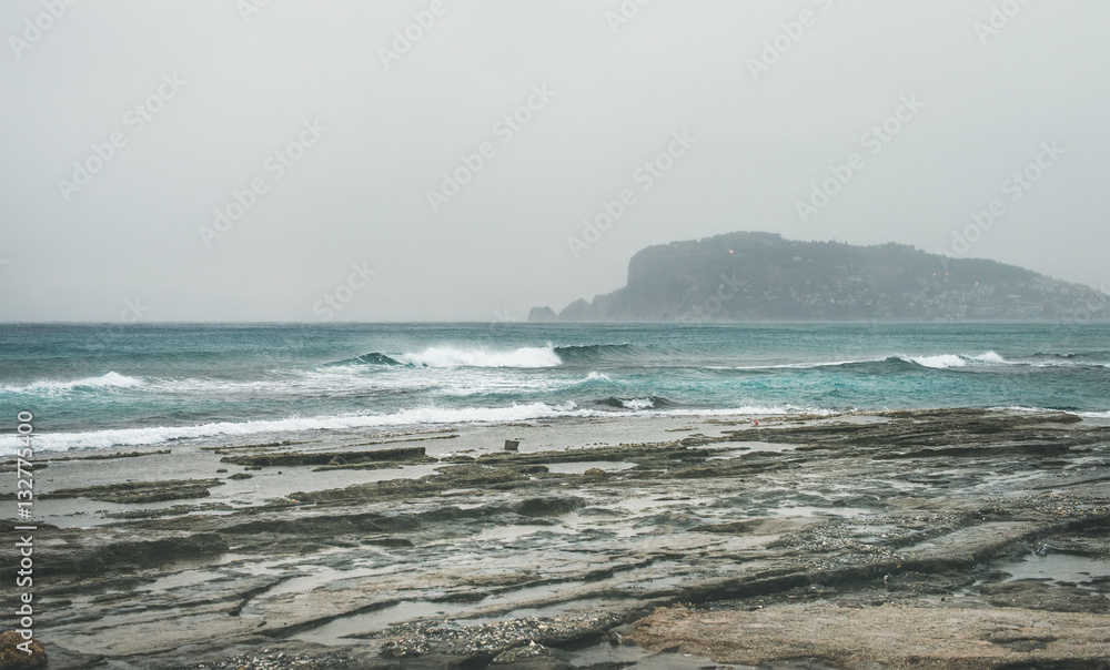 Stormy winter day with waves at Mediterranean sea coast in Alanya, Mediterranean region, Turkey