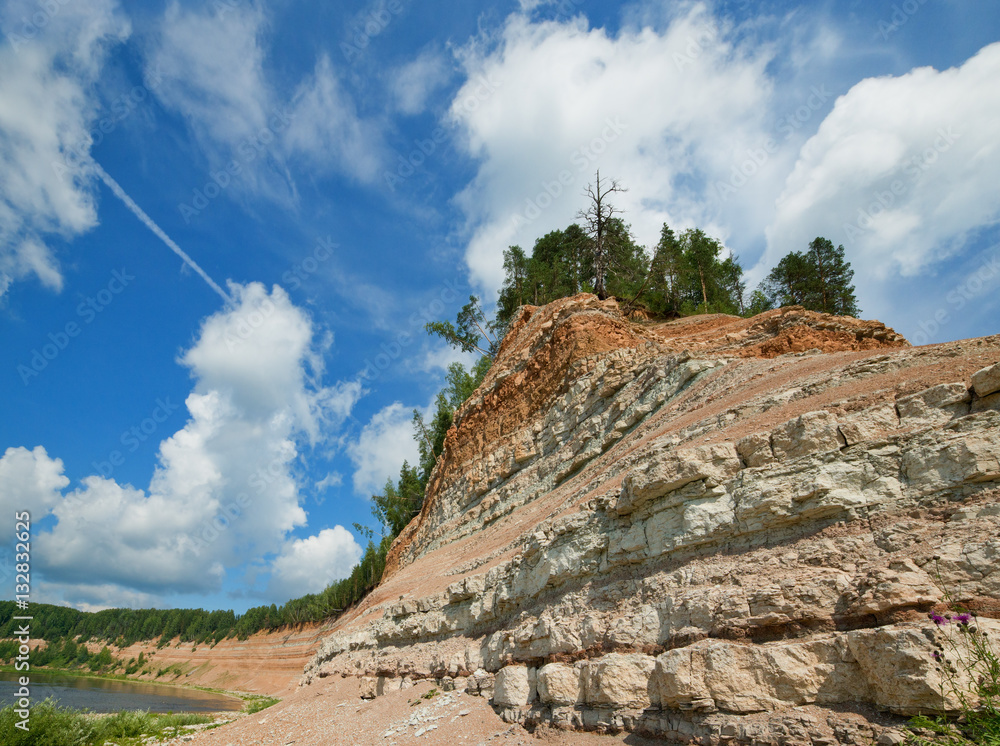 The steep coast put from layered limestones on Sukhona River.