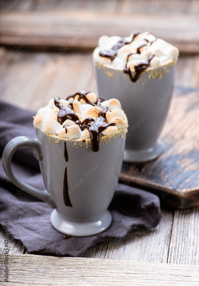 Smores drink. Two mugs of hot chocolate with marshmallows on a wooden table. Cocoa.