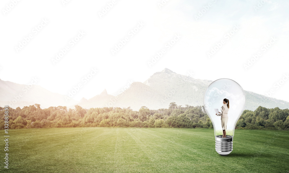 Businesswoman inside light bulb