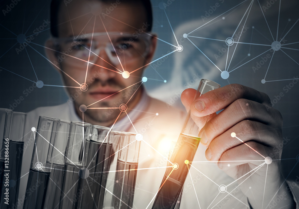 Portrait of concentrated male scientist working with reagents in laboratory