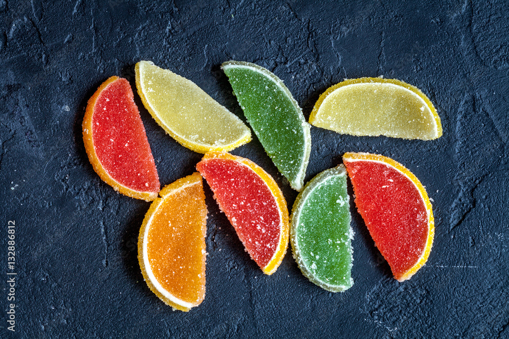 sweets and sugar candies on dark background top view