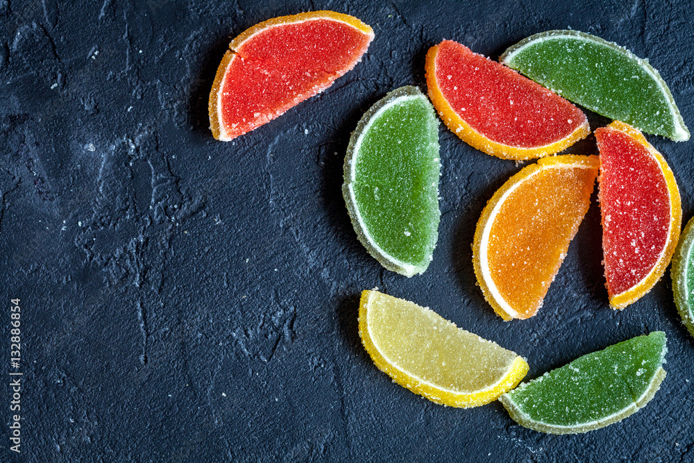 sweets and sugar candies on dark background top view