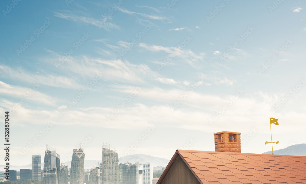 Brick house roof and modern cityscape at background