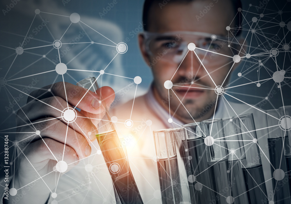 Portrait of concentrated male scientist working with reagents in laboratory