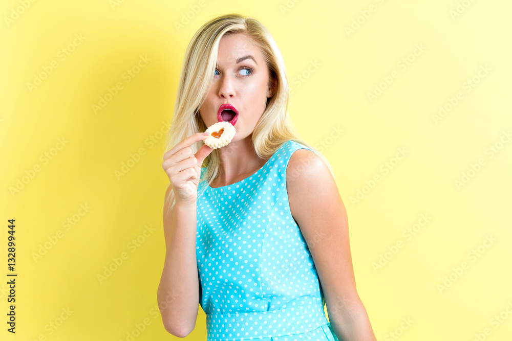 Happy young woman with cookie