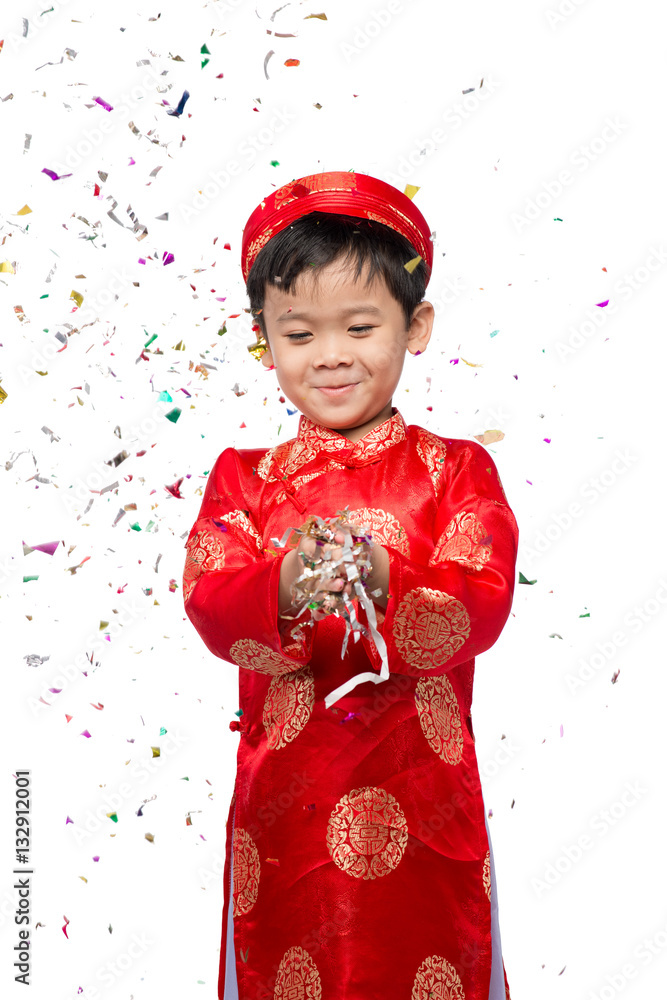 Happy Vietnamese boy in red Ao Dai celebrating New Year with con with con