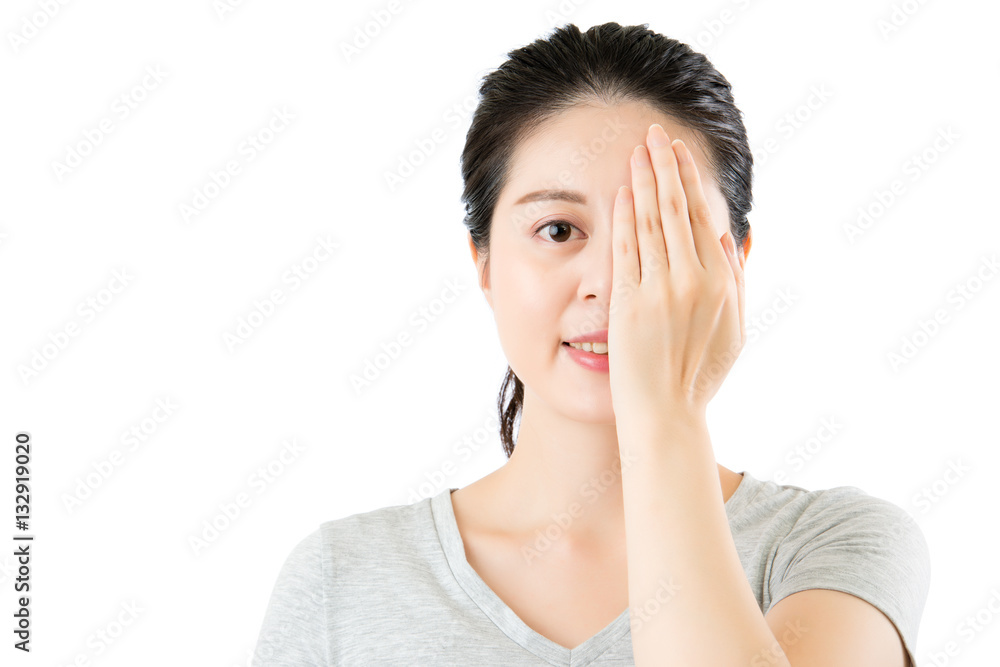 asian woman reviewing eyesight. closing one eye with hand