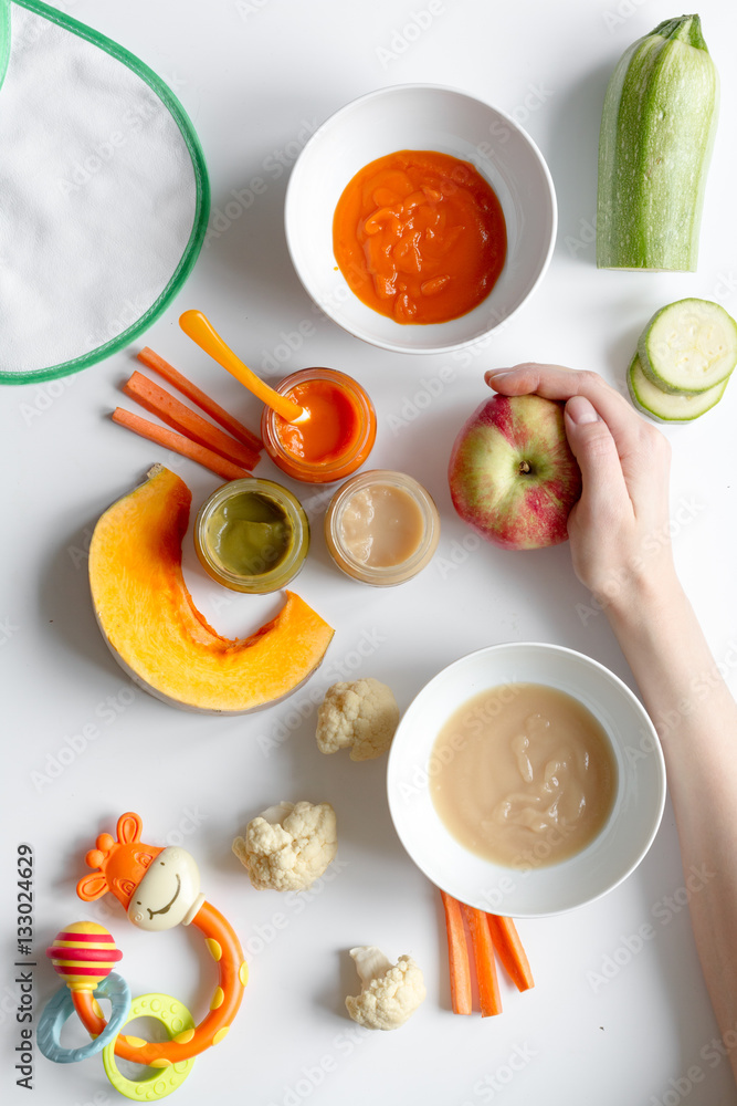 cooking vegetable puree for baby on white background top view