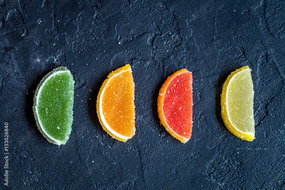 sweets and sugar candies on dark background top view