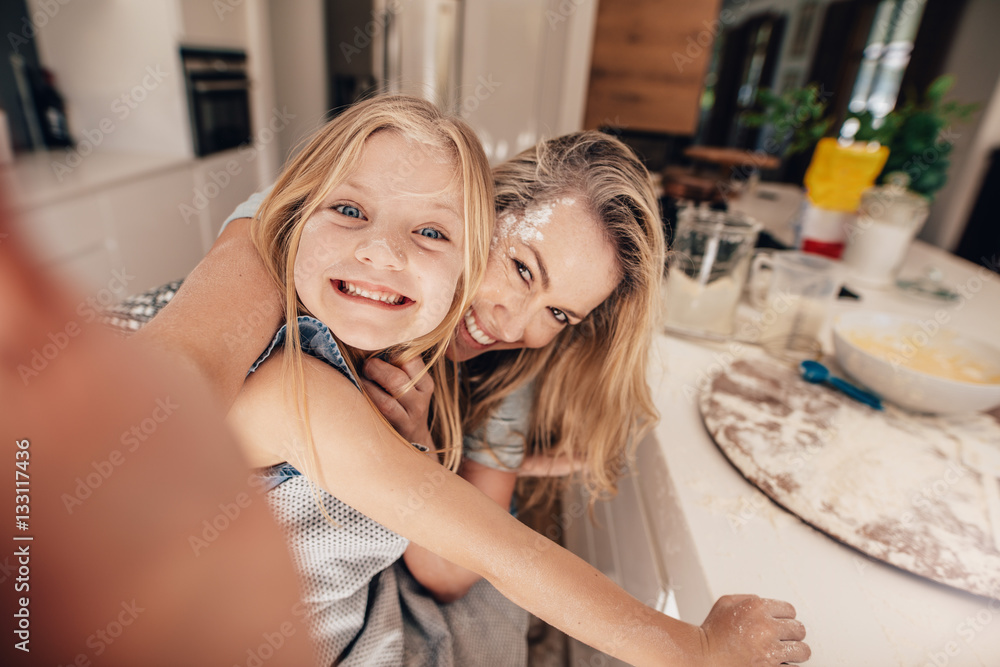 Happy family taking a selfie in kitchen