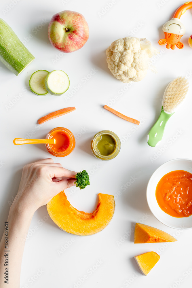 cooking vegetable puree for baby on white background top view