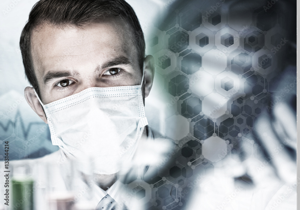 Young scientist mixing reagents in glass flask in clinical laboratory