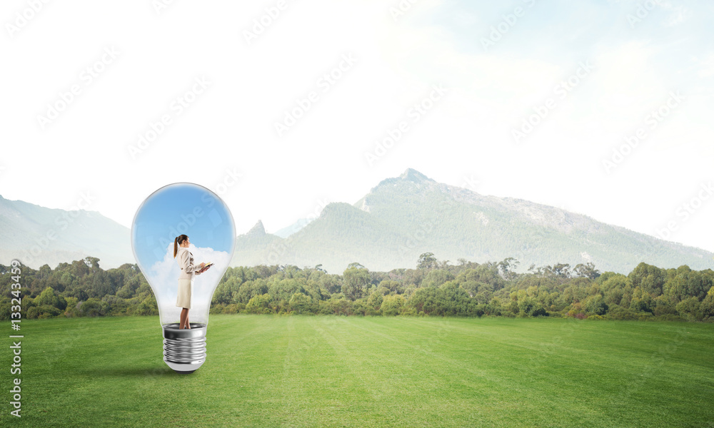 Businesswoman inside light bulb