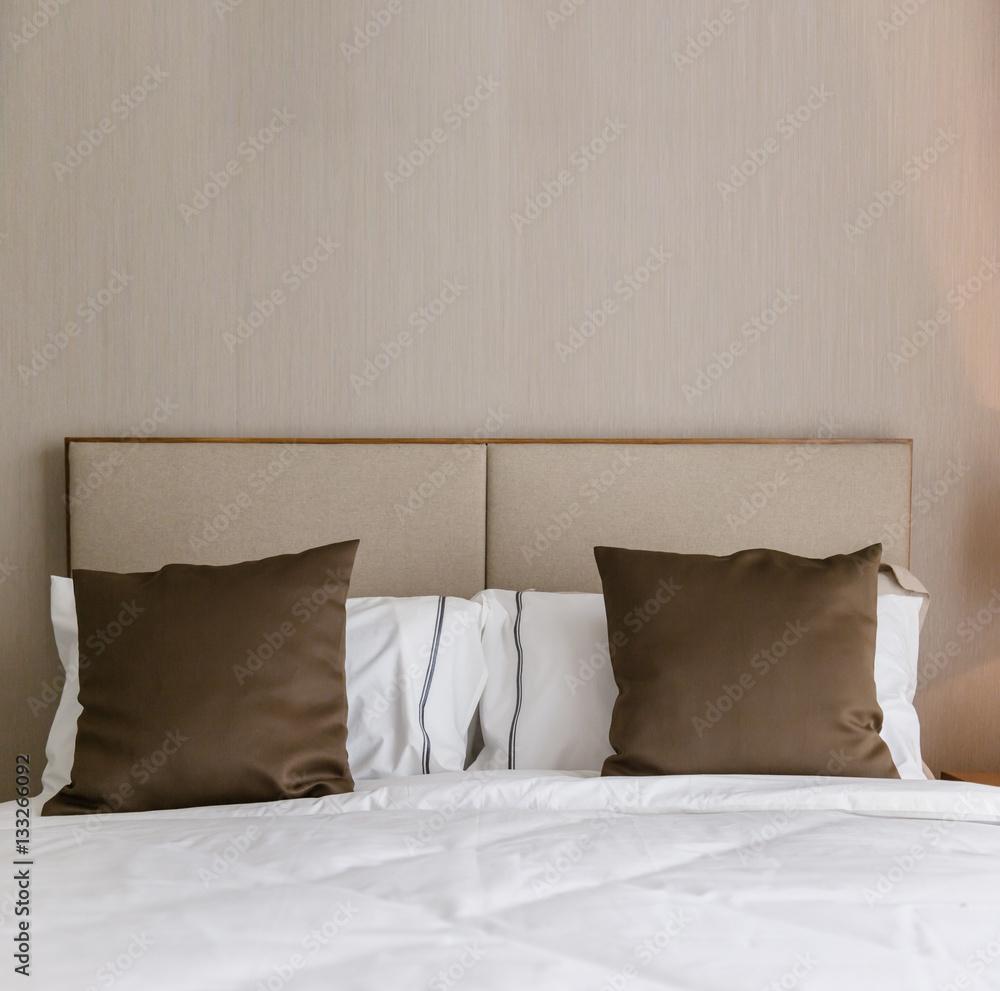 Bed maid-up with clean white pillows and bed sheets in beauty ro