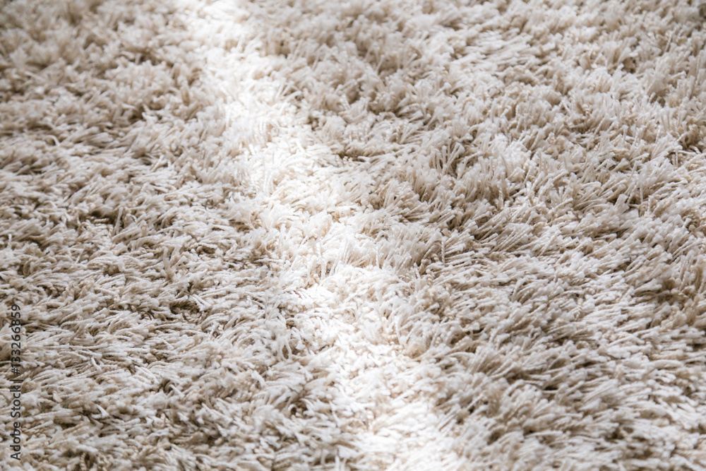 beige color domestic carpet texture with light spot from window