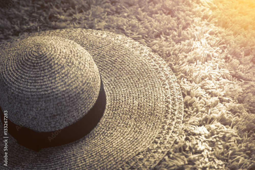 Womens Wide Brim Straw Hat on rug with light from white window