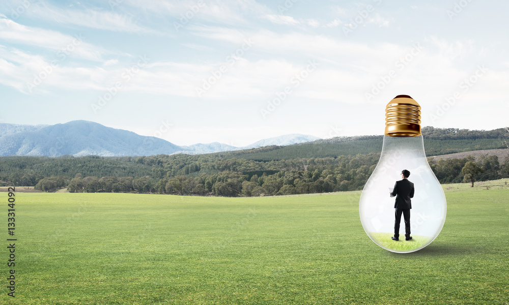 Businessman inside light bulb