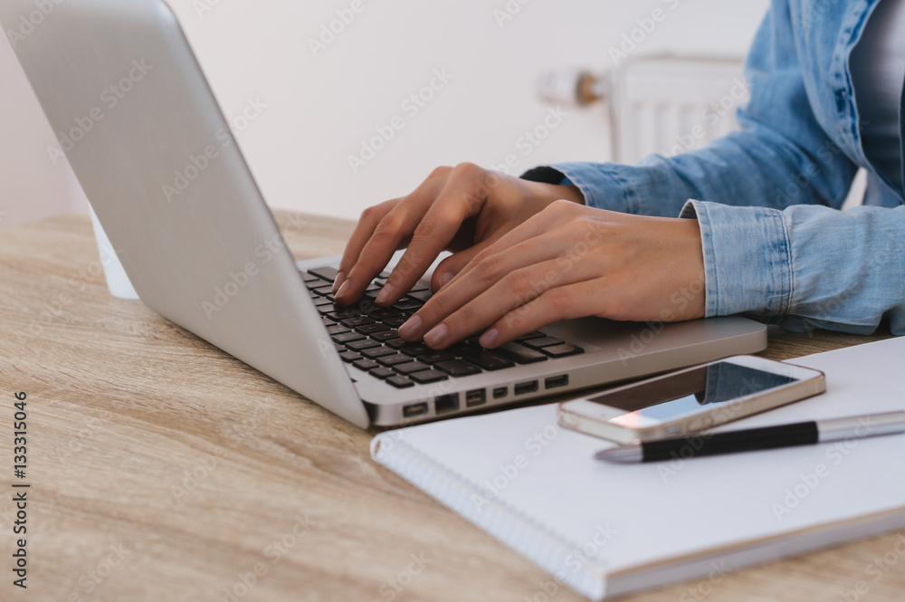 Closeup of a hands busy typing on a laptop