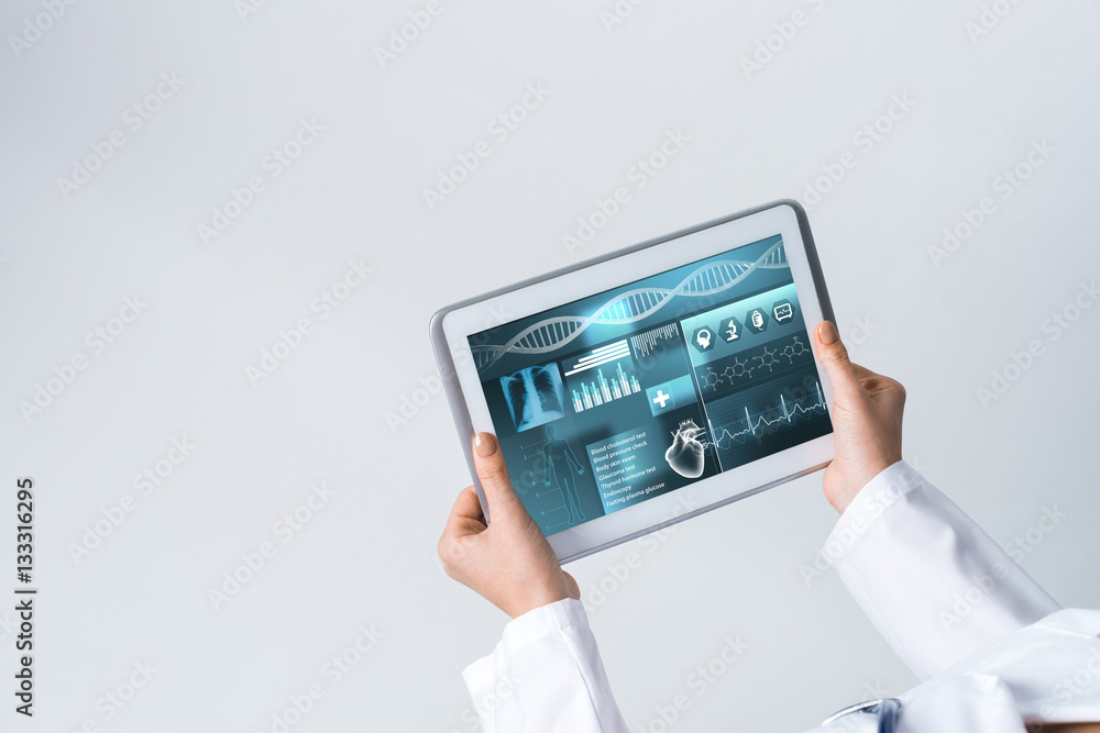 Close of female doctor hands working with tablet pc computer