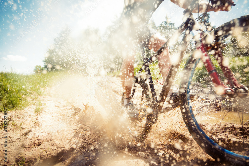 Mountain Biker Riding Through A Dirty Puddle