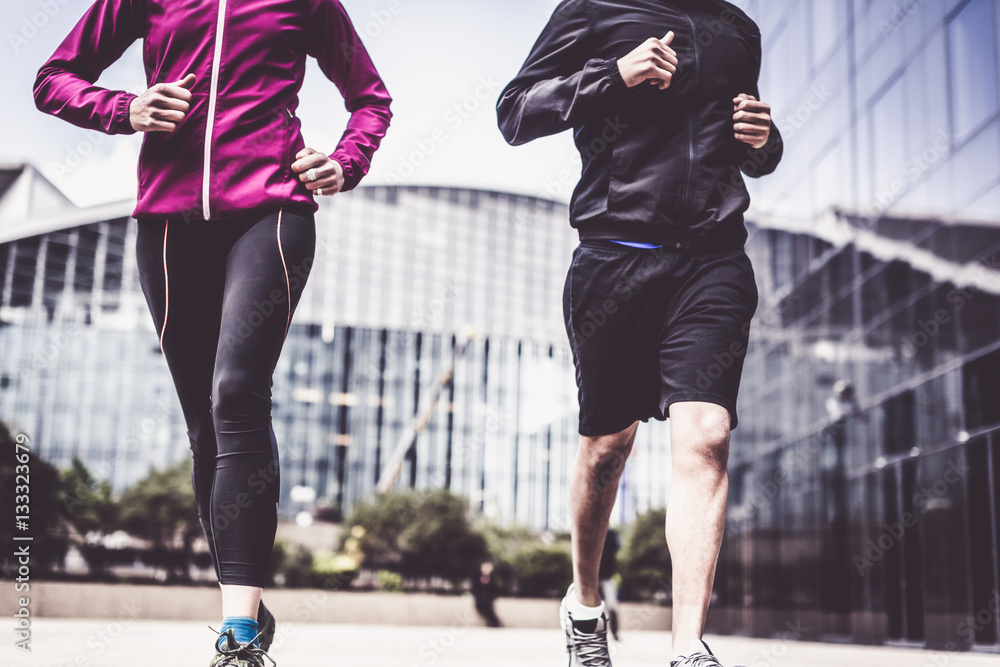 Multi-ethnic Couple Jogging In Urban Setting