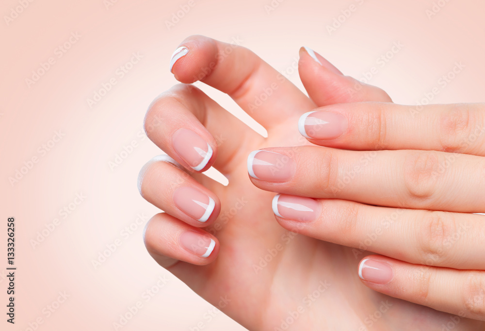 Female hands with french manicure. Spa and skincare concept