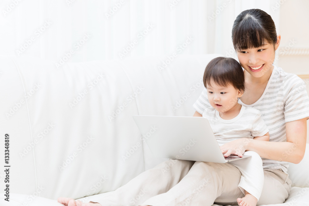 asian baby and mother using laptop