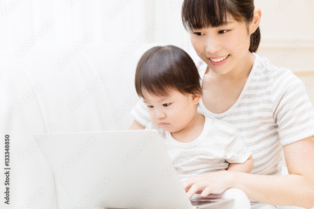 asian baby and mother using laptop