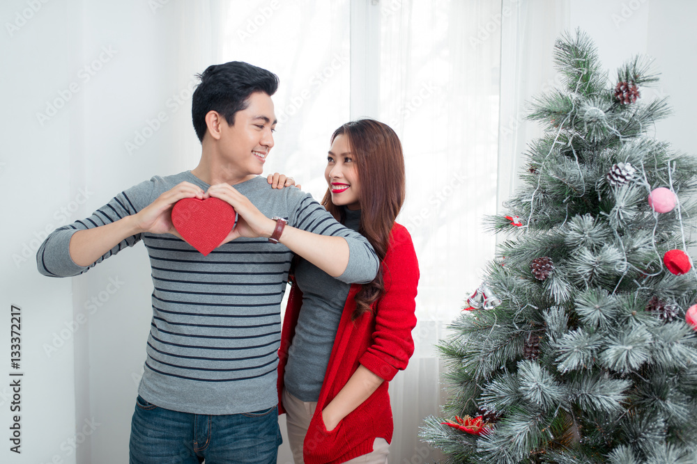 Christmas Asian Couple. A handsome man giving her girlfriend/wif