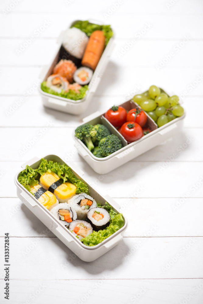 Bento box with different food, fresh veggies and fruits