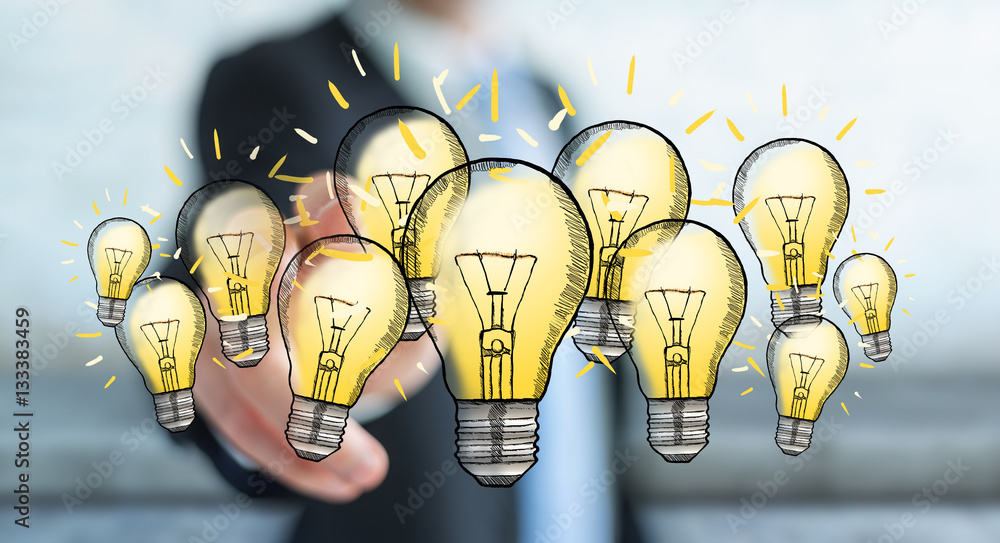 Businessman touching hand-drawn lightbulb with his finger