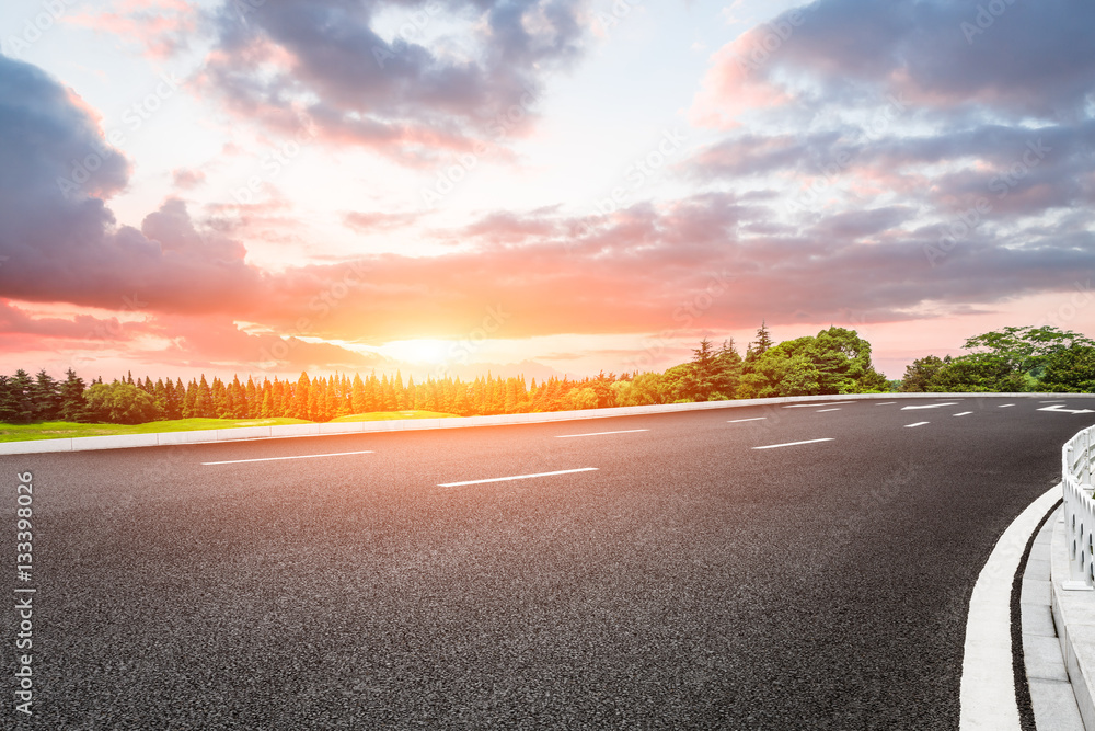 Beautiful rural asphalt road scenery at sunset