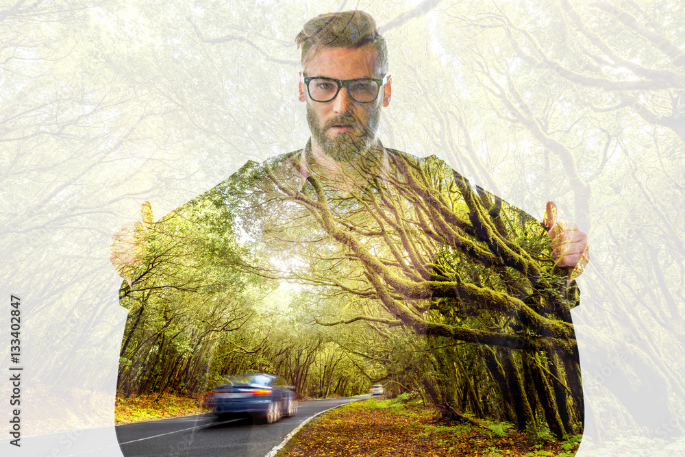 Double exposure portrait of a businessman with jacket combinated with beautiful green forest landsca