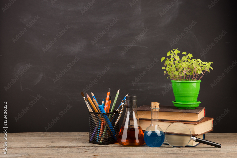 Education concept - books on the desk in the auditorium