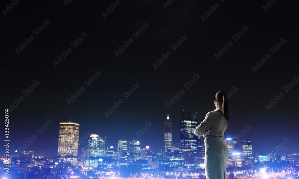 Woman looking at night city