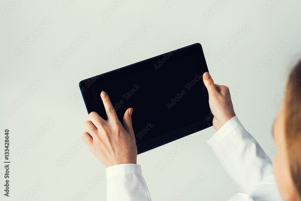 Close of female doctor hands working with tablet pc computer