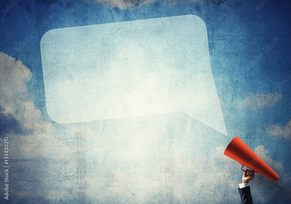 Hand of businesswoman holding red paper trumpet and speech cloud